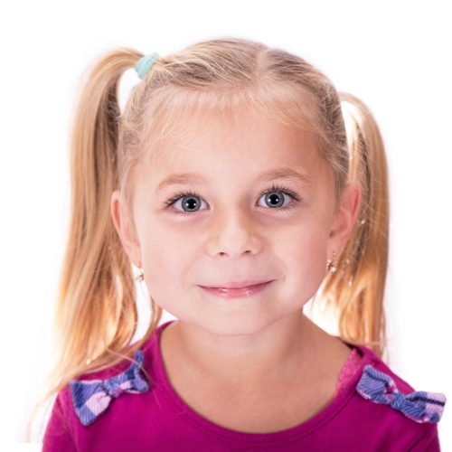 Portrait of a happy smiling child girl on a white background