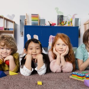 full-shot-kids-sitting-together-kindergarten